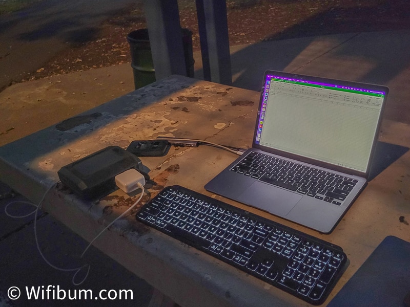 A photo of me testing an Omnicharge Ultimate for working remotely. The image is working remotely from a picnic table at a park and an Apple MacBook Air is plugged into the Omnicharge.